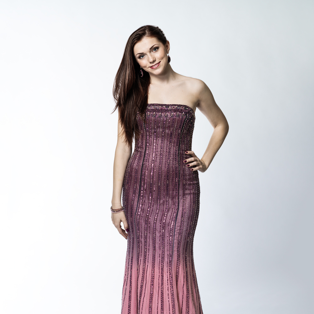 Fashion model image with glamour retouching applied to skin, makeup, and lighting.
